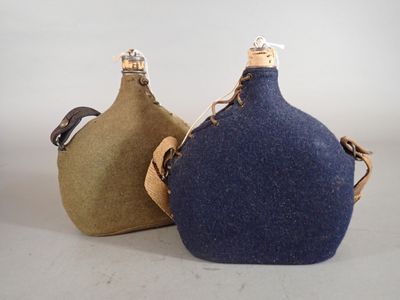 two flasks sitting next to each other on a table