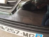 a reflection of a person sitting in the back of a car
