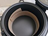a black pot with a paper liner inside of it