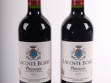 two bottles of red wine sitting next to each other on a white surface