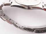 a close up of a wrist watch on a white surface
