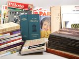 many books stacked on top of each other on a table