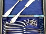 silverware in a blue box with forks and spoons in it