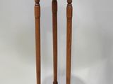 an old wooden table with two legs and a round top