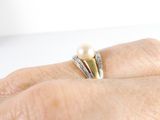 a close up of a person ' s hand with a ring on it