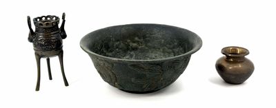 a bowl and a vase sitting next to each other on a white surface