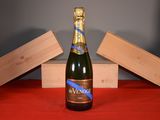 a bottle of wine sitting on a table next to a box