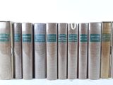 books are lined up in a row on a white surface