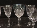 several empty wine glasses are lined up on a black surface