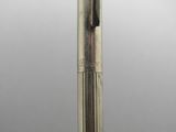 a close up of a silver pen with a black nib