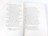 an open book on a white table with writing on it