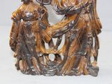 a figurine of a woman and a man holding a baby