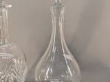 two glass vases sitting next to each other on a table