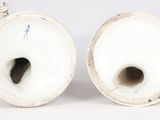 pair of white porcelain vases with blue handles on a white background