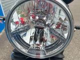 a close up of a motorcycle ' s headlight on a street