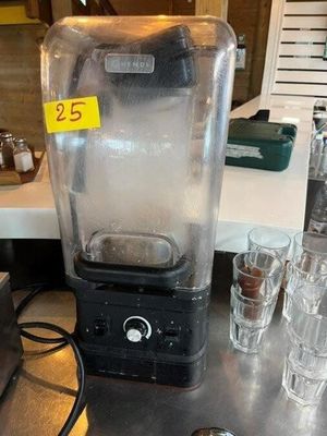 a blender that is sitting on a counter next to glasses