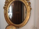 a mirror on the wall above a radiator in a room