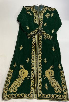 a green and gold embroidered robe with peacocks on it