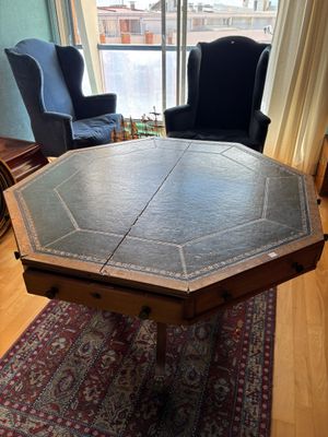 a table with a leather top in a living room