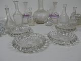 a lot of glass vases and other glass items on the table