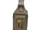 a bottle with a candle inside of it on a white background