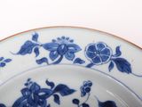 a blue and white plate with blue flowers on it