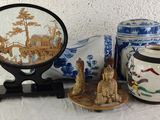 three vases and a mirror sitting on a table