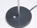 a black lamp that is on top of a white table