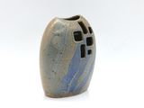 a blue and white vase sitting on a white surface