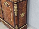 a small cabinet with a marble top in the corner of a room