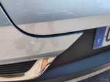 a close up of a car ' s front bumper with a number plate on it