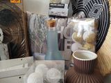 a brown vase sitting on top of a table next to other items
