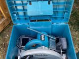 a blue tool box with a circular saw in it