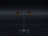 an image of a pair of gold earrings on a clear stand