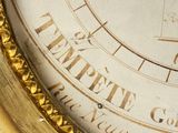 a close up of a clock with roman numerals on it