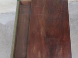 a wooden table with a drawer on top of it