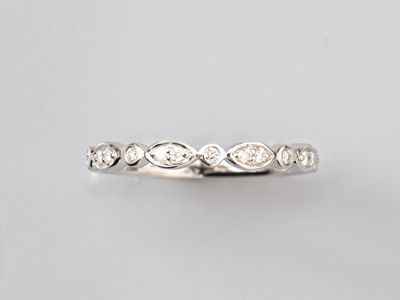 a close up of a diamond ring on a white background