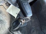 a pair of glasses and a car key on a bag