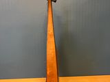 a wooden instrument on a table with a blue wall in the background
