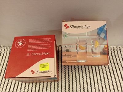 two boxes of cigarettes sitting on top of a table next to a box of cigarettes