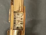 a close up of a gold watch on a table