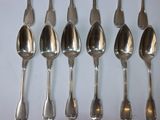six spoons that are sitting on a table