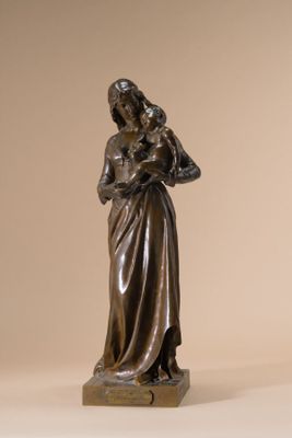 bronze statue of a woman holding a child in her arms