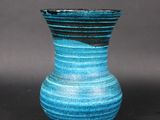 a blue vase that is sitting on a table