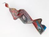 a red and blue glass sculpture on a white surface