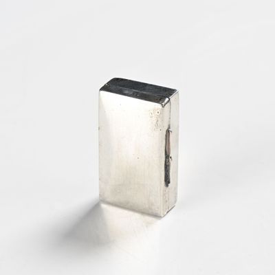 rectangular silver metal object on white background with shadow