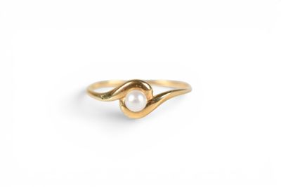 a gold ring with a pearl in the middle