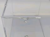 a clear box with a silver object inside of it