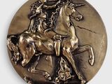 un médaillon en bronze représentant un cheval et son cavalier