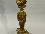 a gold lamp that is sitting on a marble base